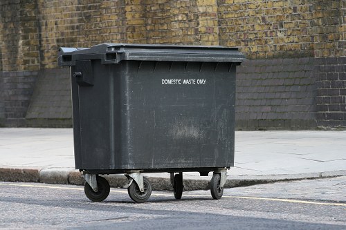 Workers wearing protective gear at a commercial waste site in Aldgate